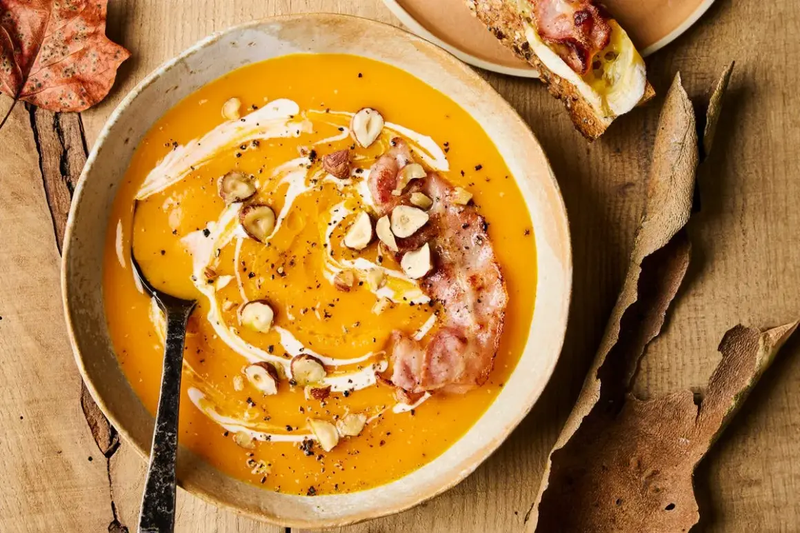Soupe de courge butternut crémeuse garnie de lardons croustillants, noisettes et filet de crème.